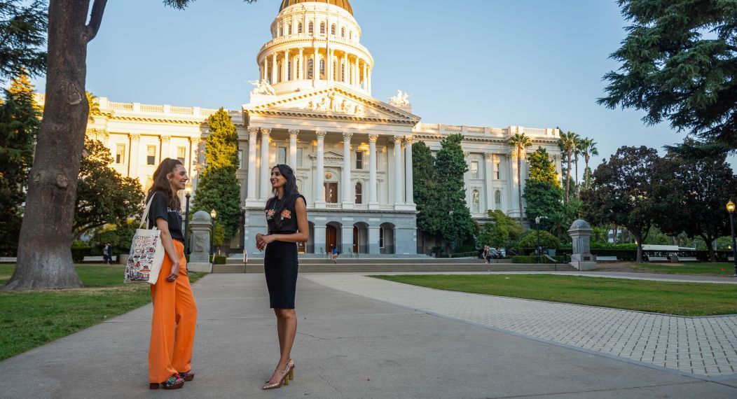 two law students standing in front of the California Capitol